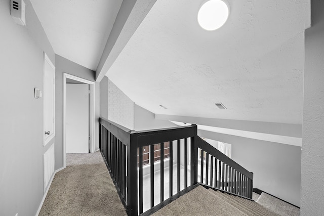 stairway featuring carpet floors and vaulted ceiling