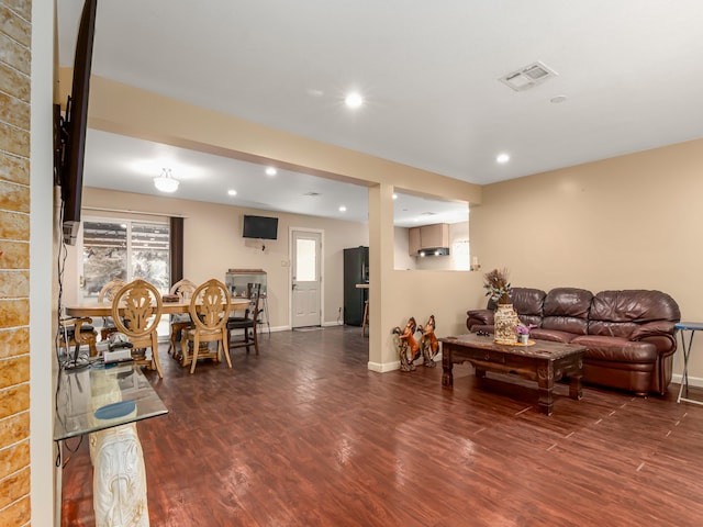 living room with dark hardwood / wood-style flooring