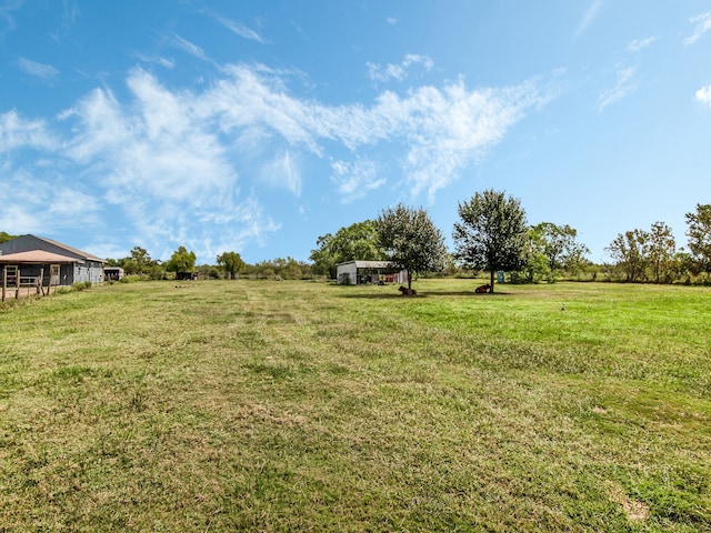 view of yard with a rural view