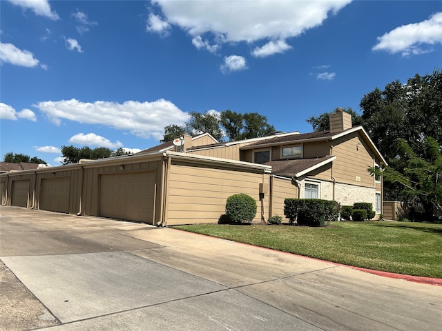 view of home's exterior with a garage and a yard