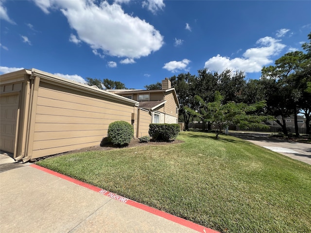 view of home's exterior with a lawn and a garage