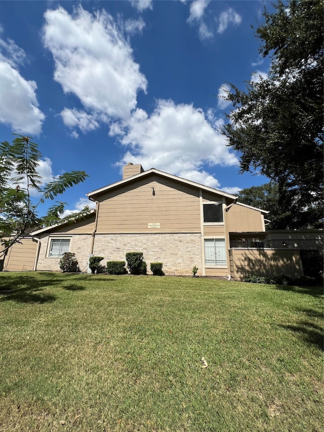 view of property exterior with a yard