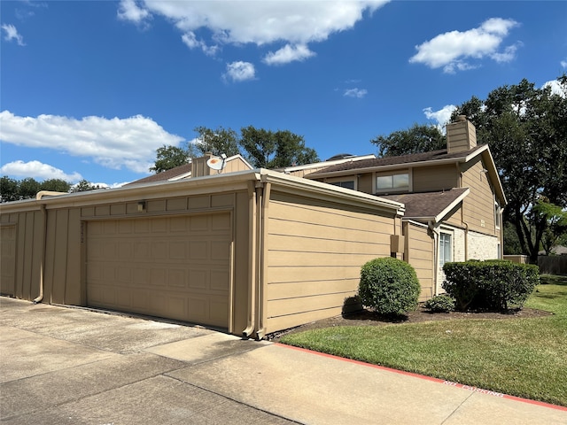 garage featuring a lawn