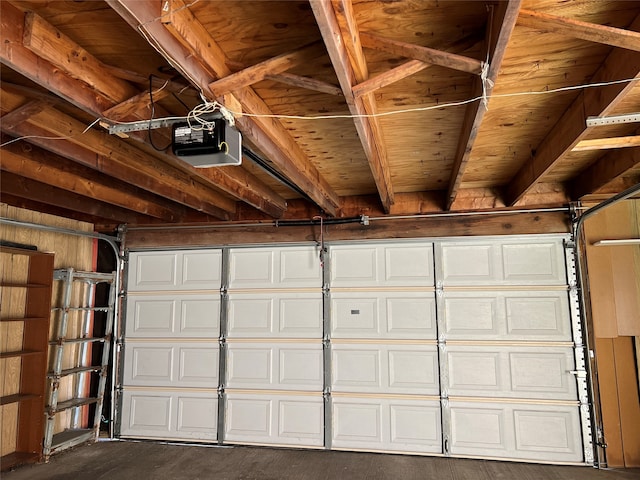 garage with a garage door opener and wood walls