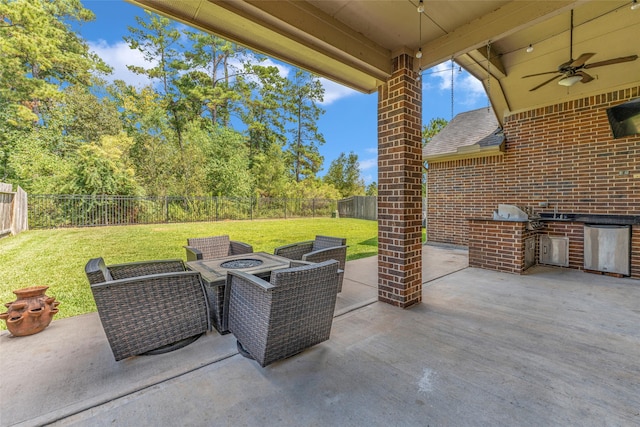 view of patio / terrace featuring area for grilling, ceiling fan, an outdoor kitchen, and an outdoor fire pit