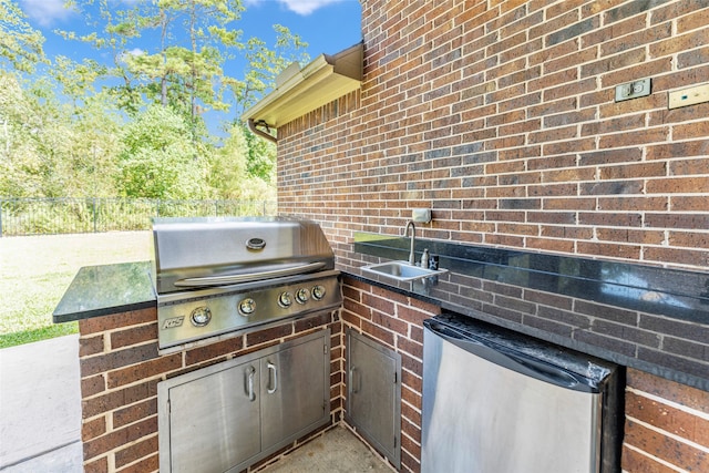 view of patio / terrace featuring a grill, sink, and exterior kitchen