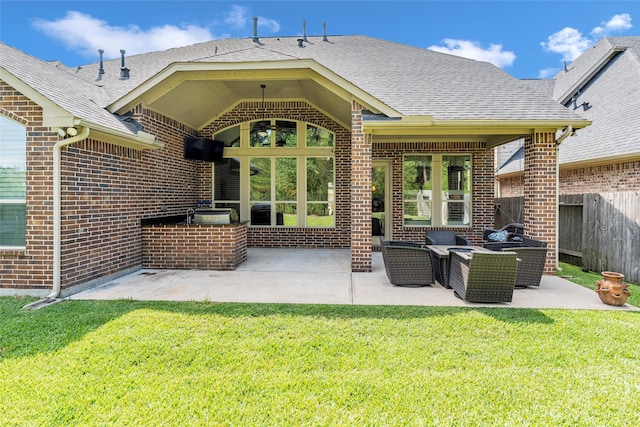 rear view of house with outdoor lounge area, a patio, area for grilling, and a lawn