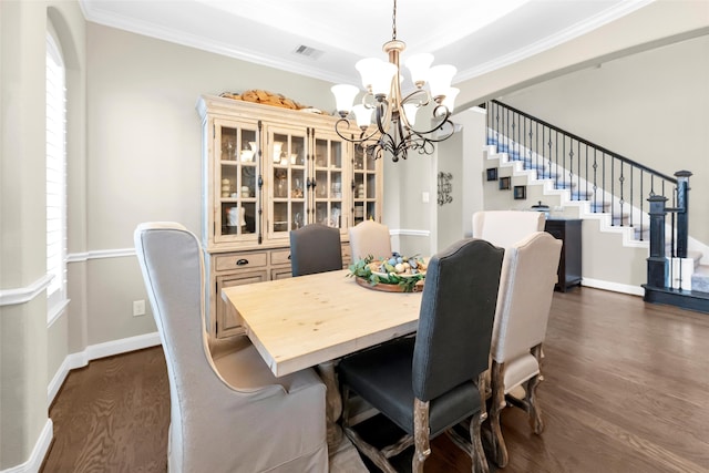 dining space with dark hardwood / wood-style flooring, crown molding, and a notable chandelier