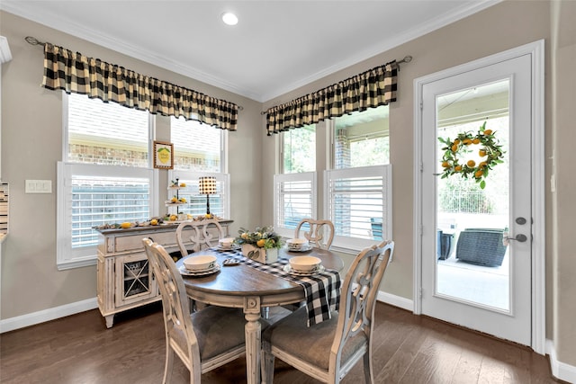 dining area with crown molding, dark hardwood / wood-style flooring, and a healthy amount of sunlight