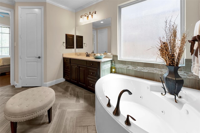 bathroom with vanity, a bathtub, and crown molding