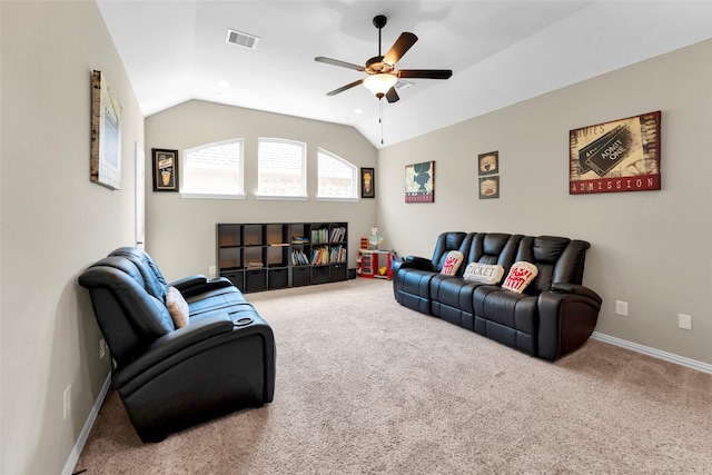 living room featuring ceiling fan, carpet floors, and lofted ceiling