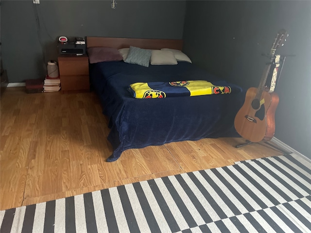 bedroom with hardwood / wood-style flooring