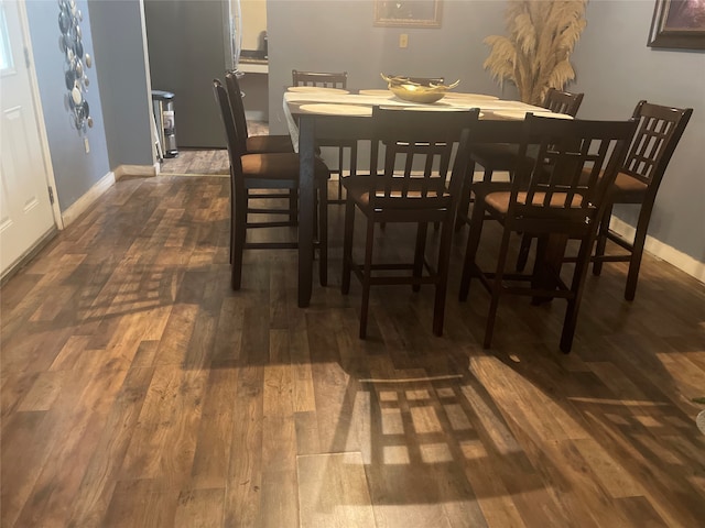 dining space featuring dark wood-type flooring