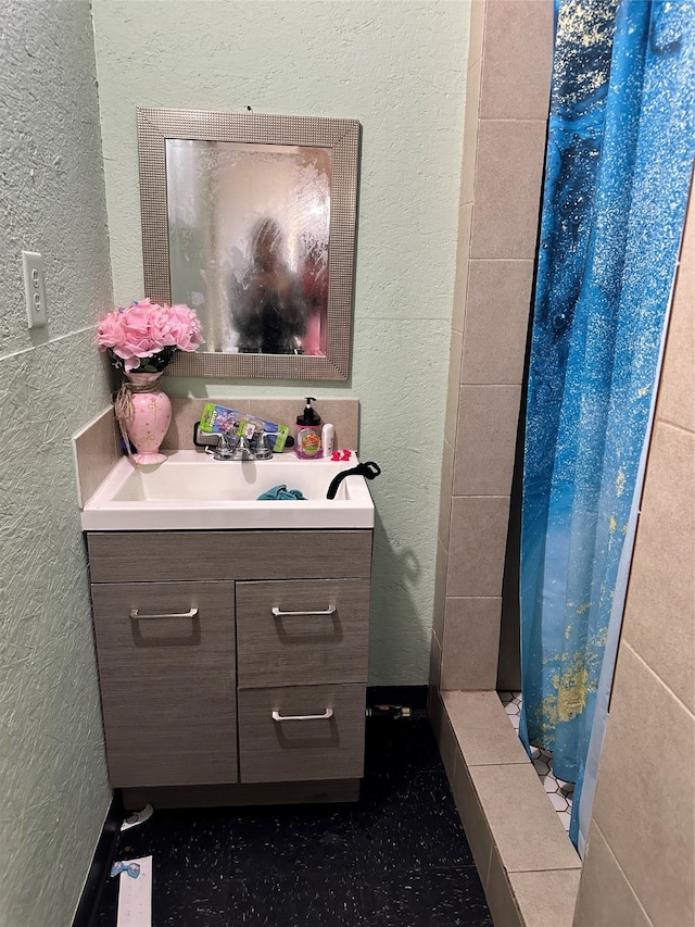 bathroom featuring vanity and a shower with shower curtain