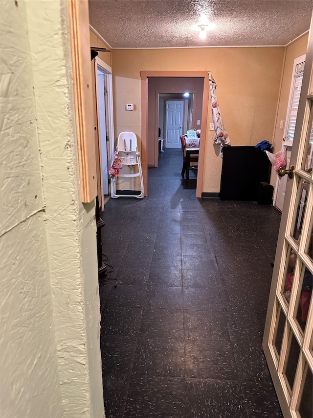 hallway with a textured ceiling