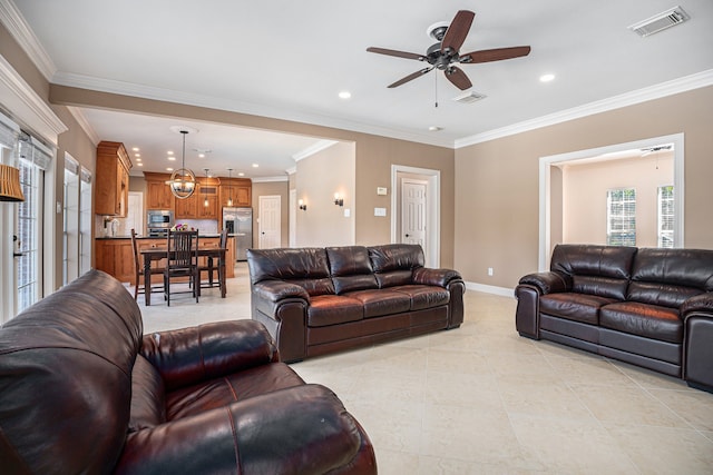 living room featuring light tile patterned floors, ornamental molding, ceiling fan, and a wealth of natural light