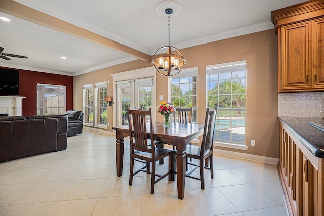 dining room featuring light tile patterned flooring, ceiling fan with notable chandelier, plenty of natural light, and crown molding