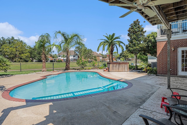 view of swimming pool with ceiling fan and a patio area