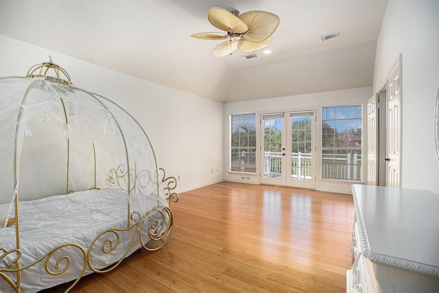 bedroom with light wood-type flooring, access to exterior, lofted ceiling, ceiling fan, and french doors