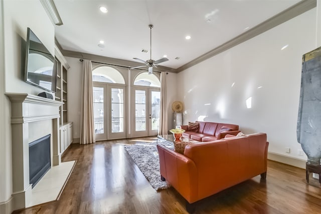 living room with ceiling fan, dark hardwood / wood-style flooring, and ornamental molding