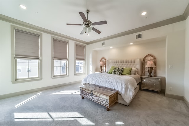 carpeted bedroom featuring ceiling fan and crown molding