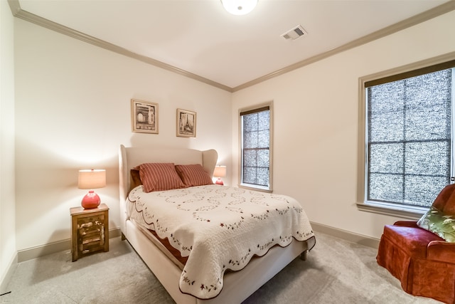 bedroom with light colored carpet, multiple windows, and crown molding