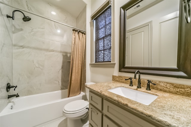 full bathroom featuring shower / bath combo with shower curtain, vanity, and toilet