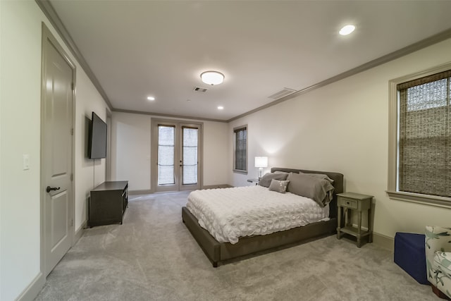 carpeted bedroom with crown molding and french doors