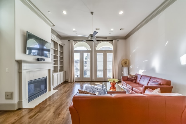 living room featuring ceiling fan, hardwood / wood-style floors, and ornamental molding