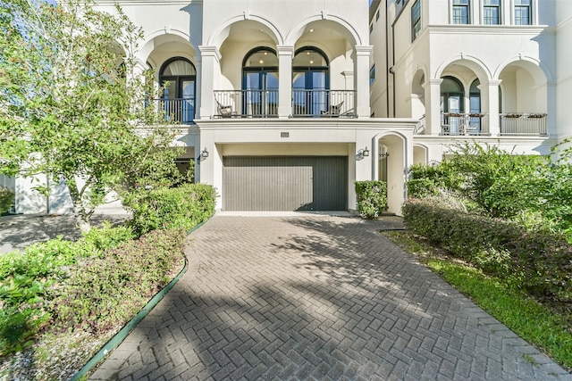 view of front of property with a balcony and a garage