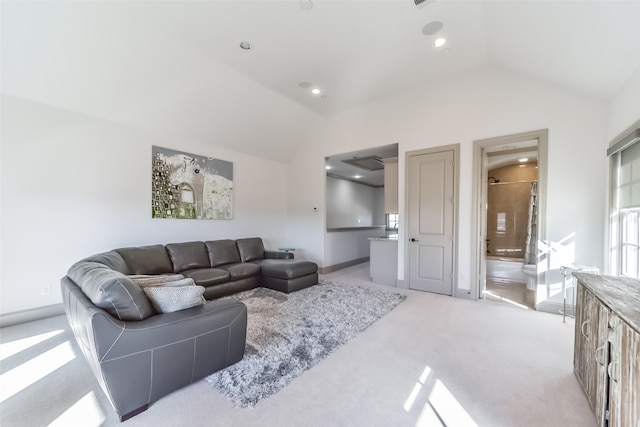 living room with light carpet and vaulted ceiling