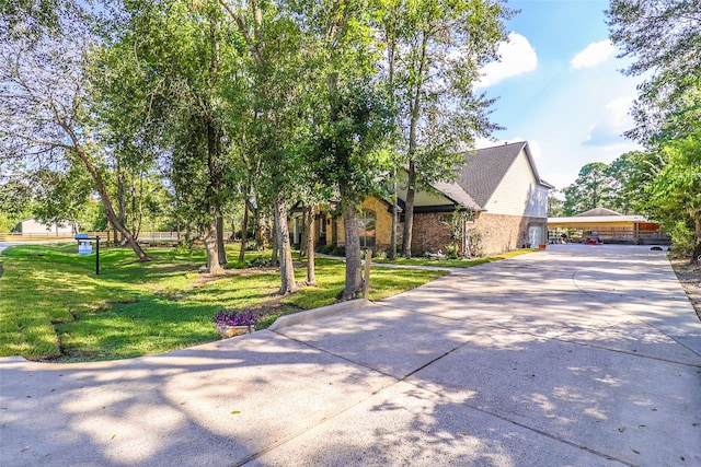 exterior space featuring a carport and a front yard