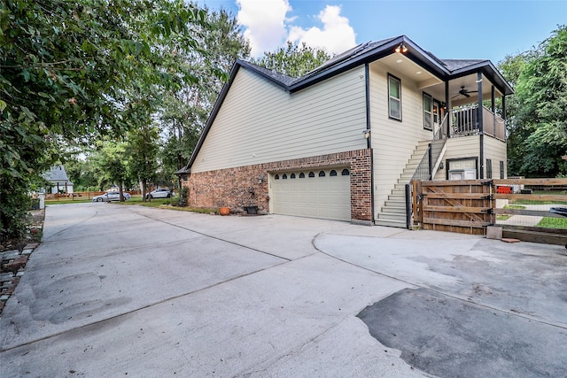 view of side of home with a balcony and a garage