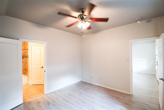 spare room featuring light wood-type flooring and ceiling fan