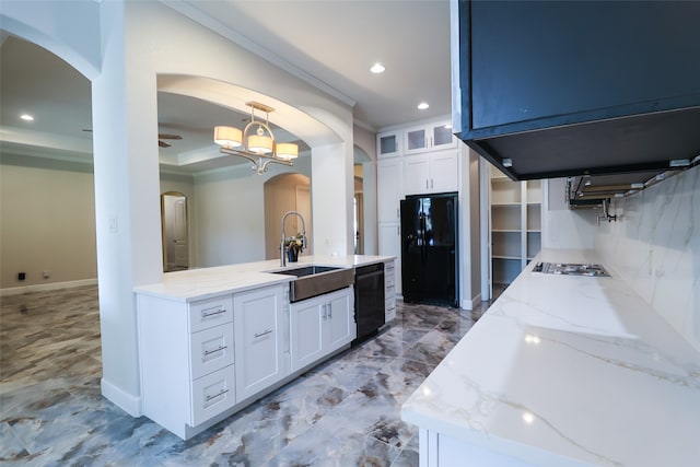 bathroom with ceiling fan with notable chandelier, backsplash, and vanity