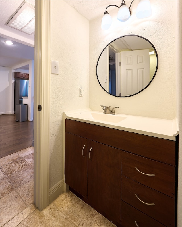 bathroom featuring vanity and hardwood / wood-style flooring