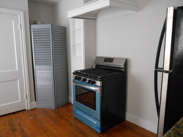 kitchen featuring stainless steel appliances and dark hardwood / wood-style flooring