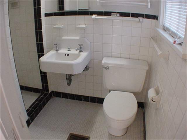 bathroom with sink, tile patterned floors, walk in shower, tile walls, and toilet