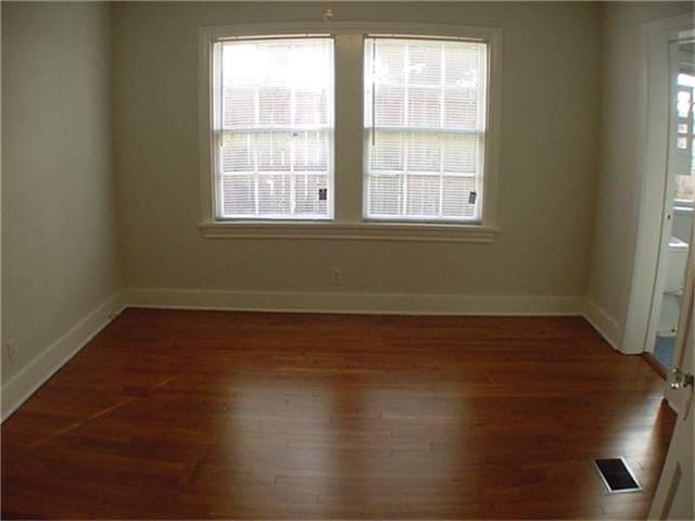 spare room featuring dark hardwood / wood-style floors and plenty of natural light