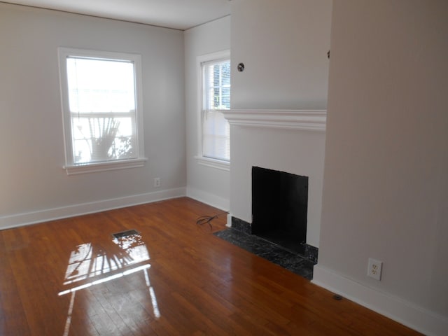 unfurnished living room featuring wood-type flooring