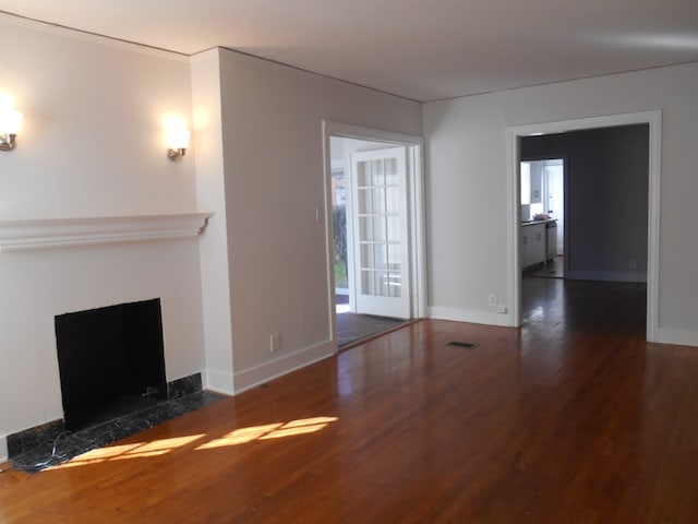 unfurnished living room featuring dark hardwood / wood-style floors