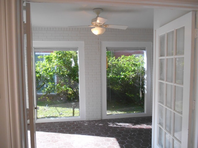 interior space with ceiling fan