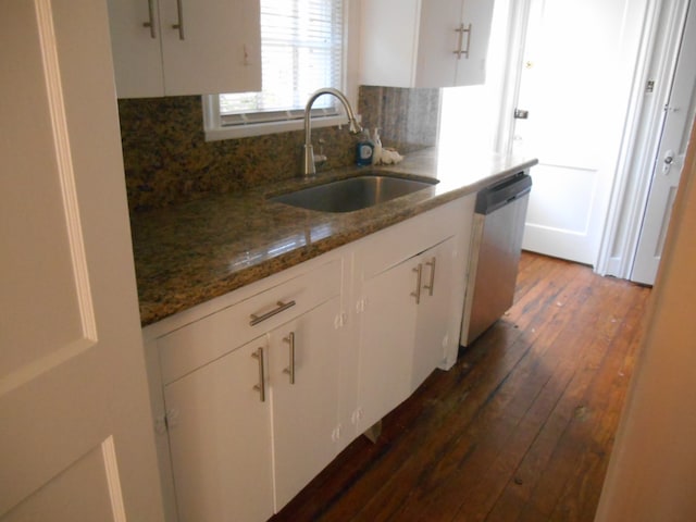 kitchen with stainless steel dishwasher, white cabinetry, and sink