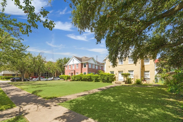 view of property's community featuring a lawn