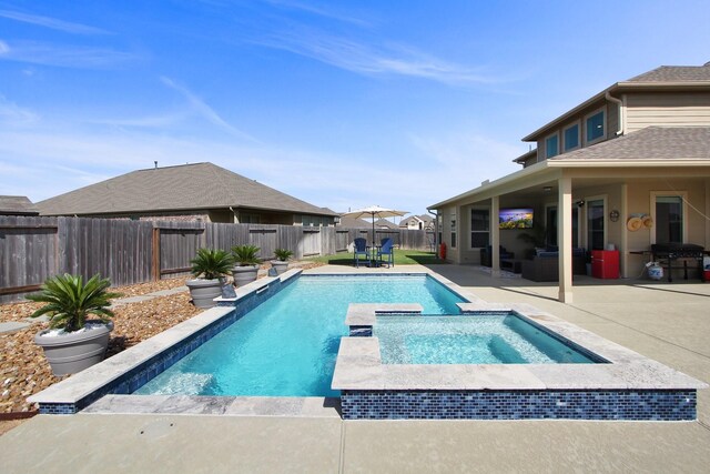 view of swimming pool with an in ground hot tub, area for grilling, and a patio