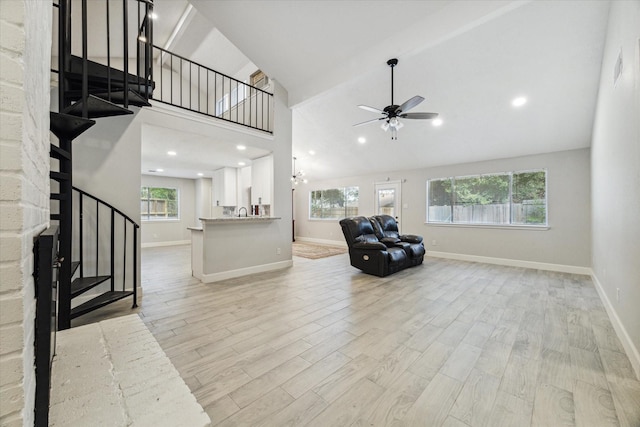 16007 Soma Dr, Houston, TX 77083 - living area featuring ceiling fan, a healthy amount of sunlight, baseboards, and stairs