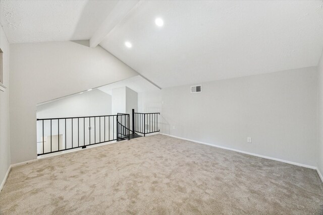 additional living space featuring carpet and lofted ceiling with beams