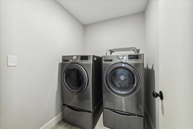 laundry area with independent washer and dryer