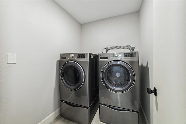 16007 Soma Dr, Houston, TX 77083 - washroom with washer and dryer, laundry area, and baseboards