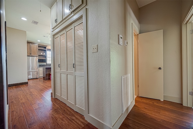 corridor with hardwood / wood-style flooring